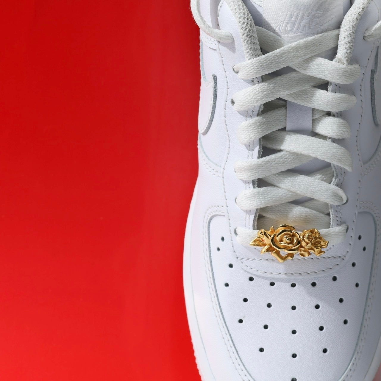 Gold rose shoe lace charm on the sneaker