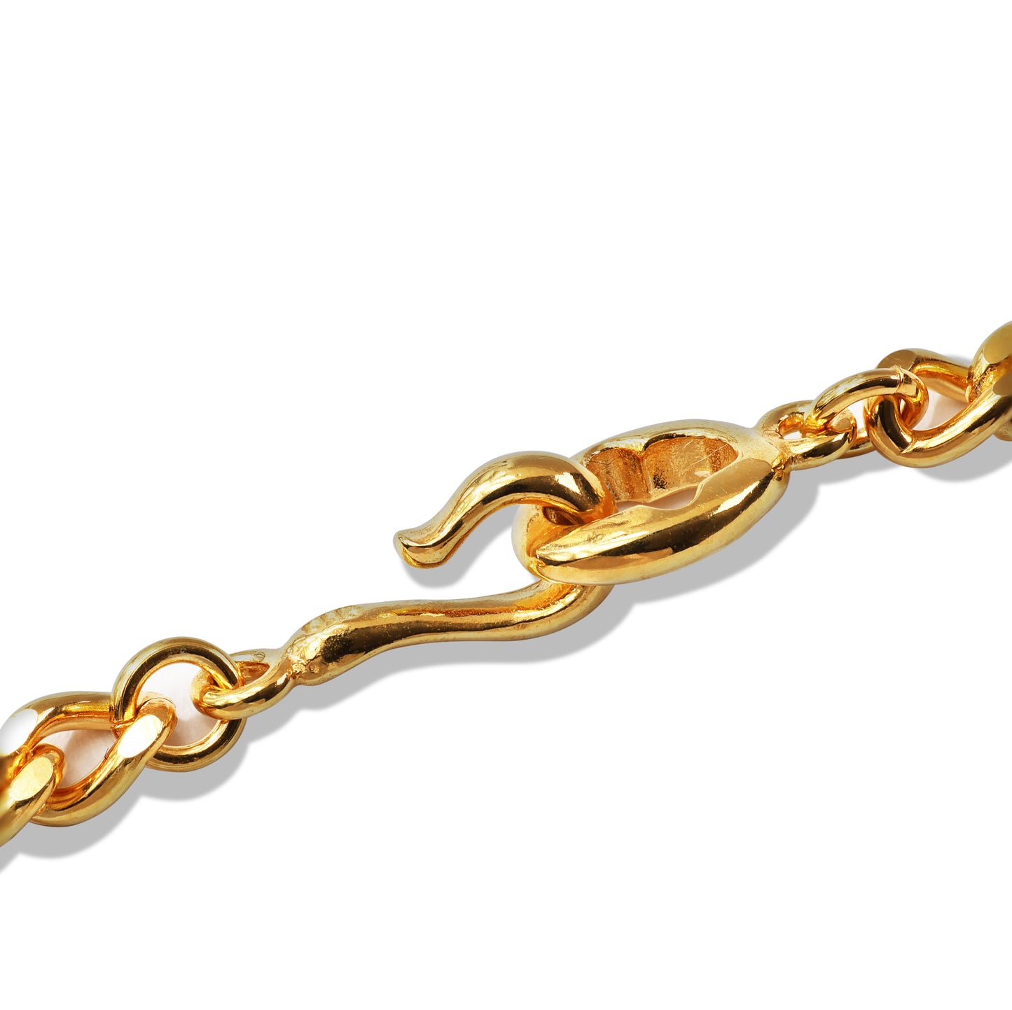 Layered gold chain necklace on black display bust