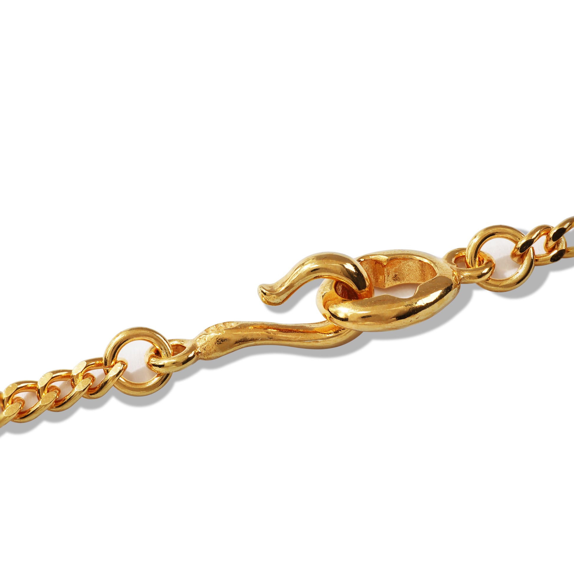 Layered gold chain necklace on black display bust