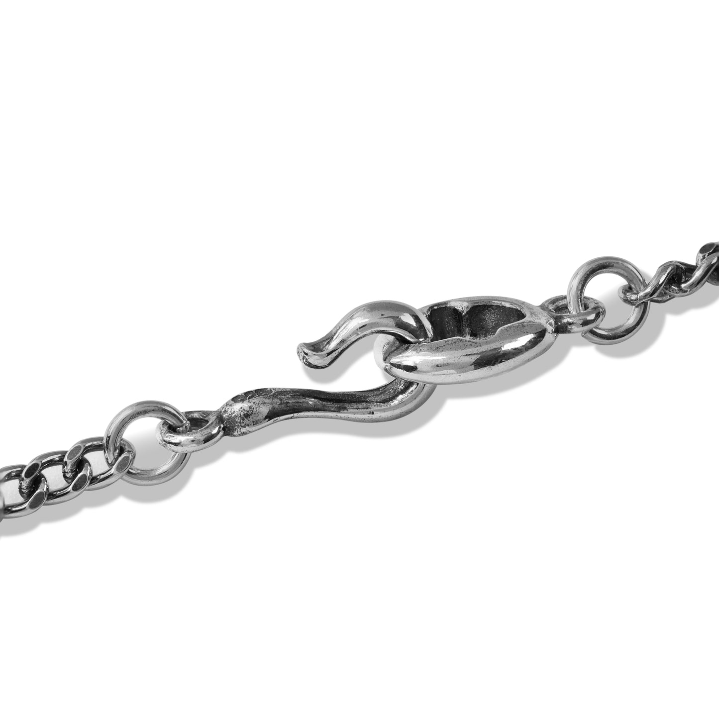 Layered silver chain necklace on black display bust