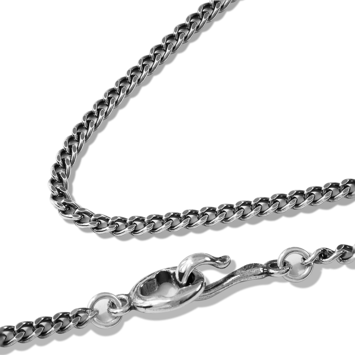 Layered silver chain necklace on black display bust