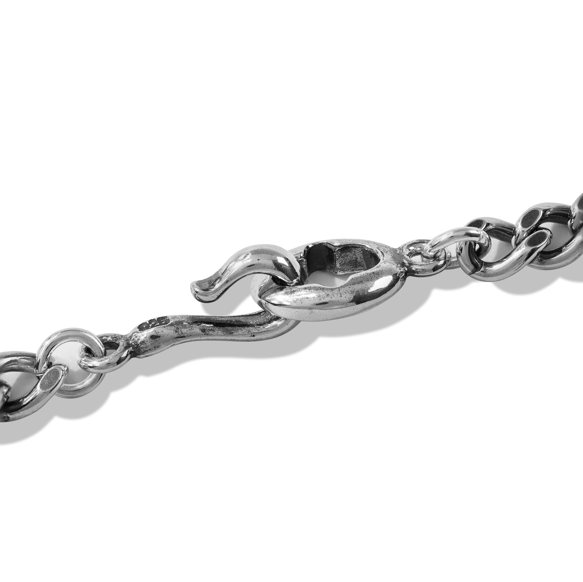 Layered silver chain necklace on black display bust