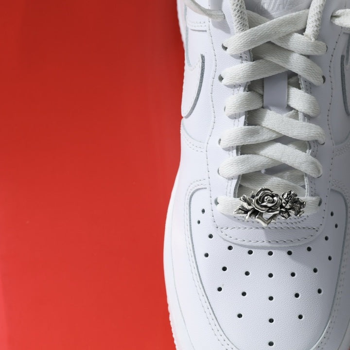 Silver rose shoe lace charm on white sneaker